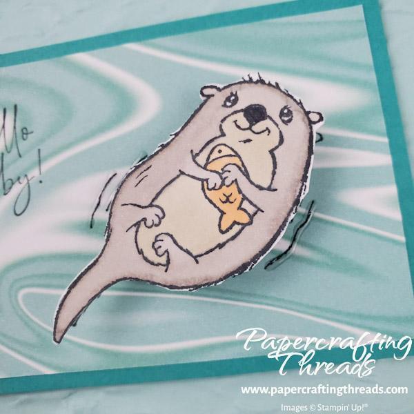 Closeup of Awesome Otters Hello Baby card with otter on an action wobble and highlighting shimmery crystal effects