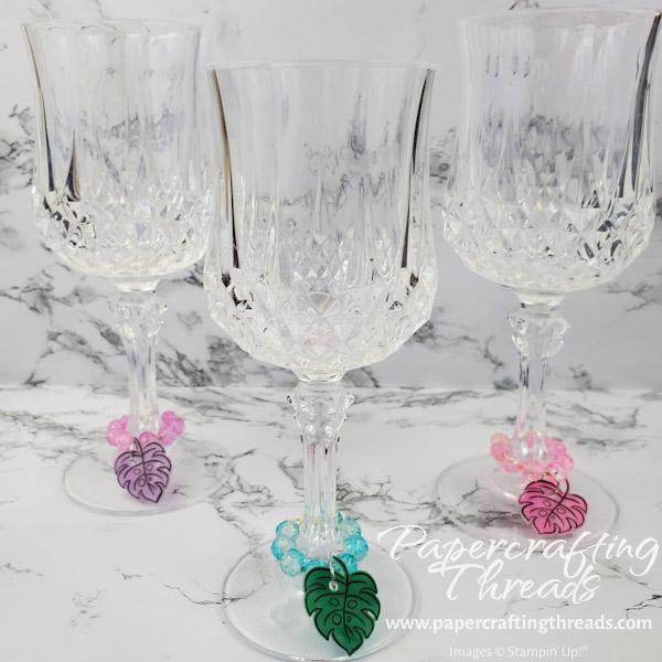 Purple, blue and pink beaded handmade wine glass charms with monstera leaf from shrink plastic