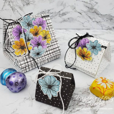 Three triad treat boxes in mini, midi and jumbo sizes in black and white with colorful flowers