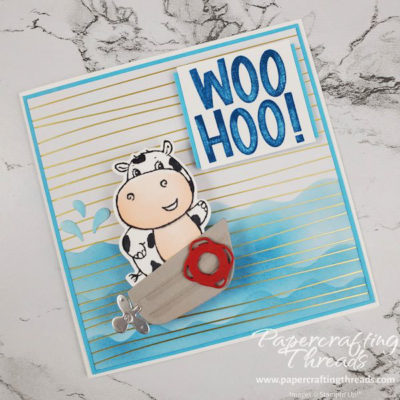 Square Card with Cow in a motor boat that moves across stamped waves with woohoo sentiment