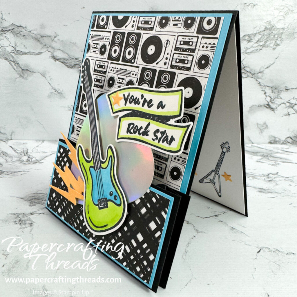Single Bridge Card side view with patterned black white rock n roll images of green blue guitar and holographic giant guitar pick with you're a rock star sentiment
