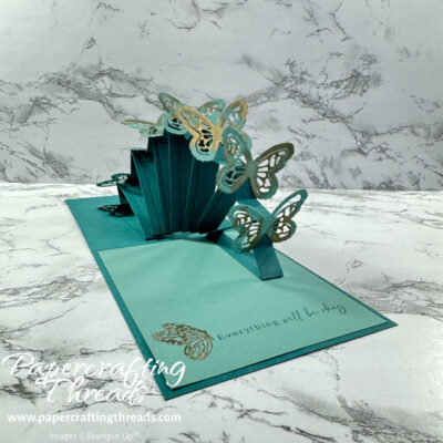 Stadium Wave Pop Up Card with teal butterflies edged with gold inside a card base with stamped butterfly and sentiment