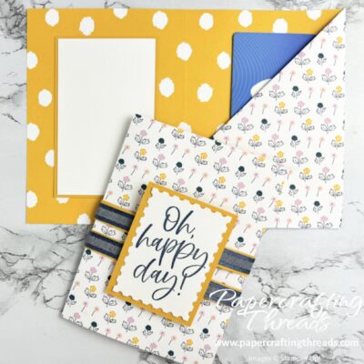 Tri Fold Gift Card Holder front with blue, pink and yellow floral pattern and large blue Oh happy day sentiment on double belly band; inside bright yellow and whitepolkadots and pocket with gift card