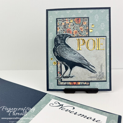 Moody card featuring Raven's Tale Stampin' Up! stamp images. Large raven focal point in shades of blue, layered over lighter blue patterned paper. A brocade pattern paper in blues and oranges is layered behind the blue square. All on a deep blue sea color card base. Gold foiled letters spell out POE. Gold sequins embellish the front.