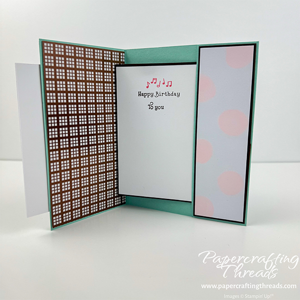 Secret Slider Card shown open. Card has a Pool Party base, with Early Espresso layers behind Barely Blush large dots pattern. The card shows the sentiment 'happy birthday to you' sliding out from a polka dotted pocket on the inside right of the card and a bronze metallic check pattern on the inside left.