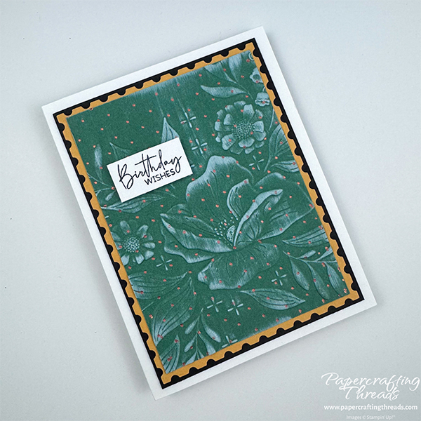 Card featuring an embossing folder technique has green embossed floral design with copper dots and white ink on the embossed raised portions. Matted on gold, then black and mounted on a white card base. Sentiment is 'Birthday wishes'.