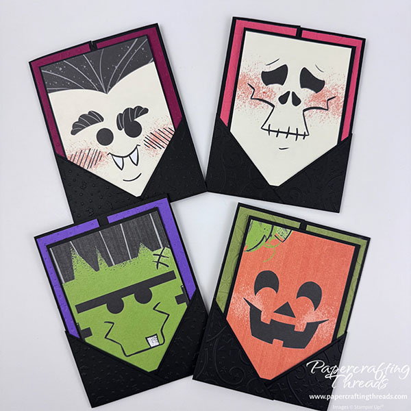Pocket Gatefold Card four ways. Black card base with gatefolds and ghouly faces flanked by overlapping triangles at base. Skeleton, vampire, Frankenstein and Jack O'Lantern.